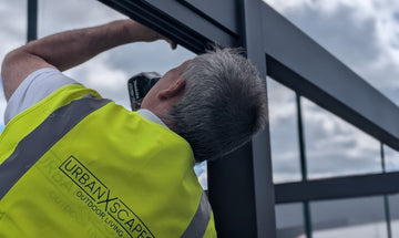One of our installation team fitting a new pergola system in Glasgow